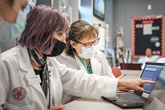 Nurses analyzing information on a computer